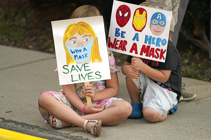 FILE - In this Aug. 6, 2021, file photo, Lucie Phillips, 6, and her brother David Phillips, 3, join parents and students during a rally at Utah State School Board Office calling for mask mandate in Salt Lake City. (AP Photo/Rick Bowmer, File)



