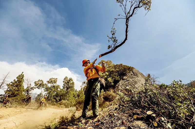 A member of the Roosevelt Hotshot Crew clears a firebreak while battling the Windy Fire on Thursday, Sept. 16, 2021, on the Tule River Reservation, Calif. His crew, which travelled from Colorado, has been battling California wildfires. (AP Photo/Noah Berger)


