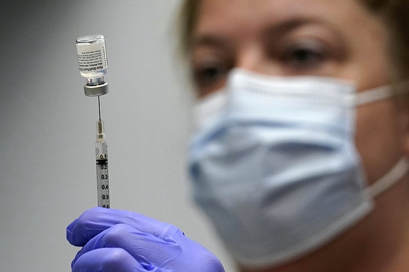 FILE - In this March 2, 2021, file photo, Hollie Maloney, a pharmacy technician, loads a syringe with Pfizer's COVID-19 vaccine at the Portland Expo in Portland, Maine. (AP Photo/Robert F. Bukaty, File)


