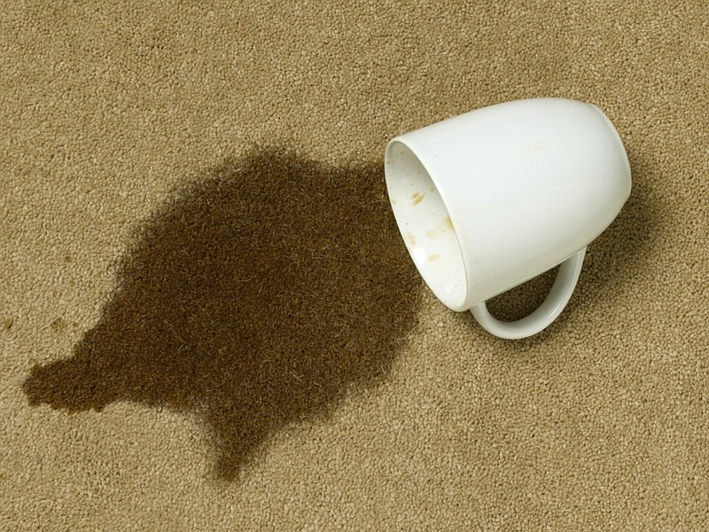 coffee and cup on carpet with stain coffee tile / Getty Images
