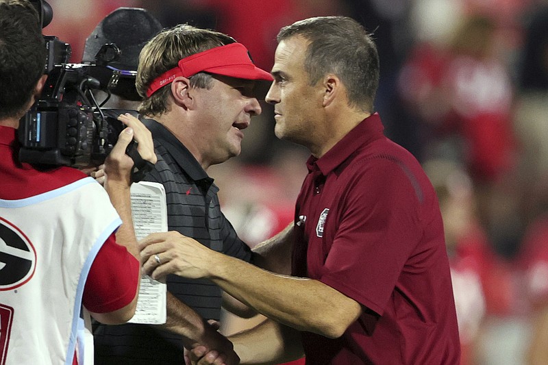 AP photo by Butch Dill / Georgia football coach Kirby Smart shakes hands with South Carolina counter Shane Beamer, right, after Smart's second-ranked Bulldogs beat the Gamecocks 40-13 in the SEC opener for both teams Saturday night in Athens, Ga.