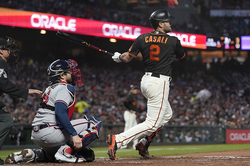 AP photo by Jeff Chiu / The San Francisco Giants' Curt Casali hits a two-run single in front of Atlanta Braves catcher Travis d'Arnaud during the fourth inning of Saturday night's game in San Francisco.