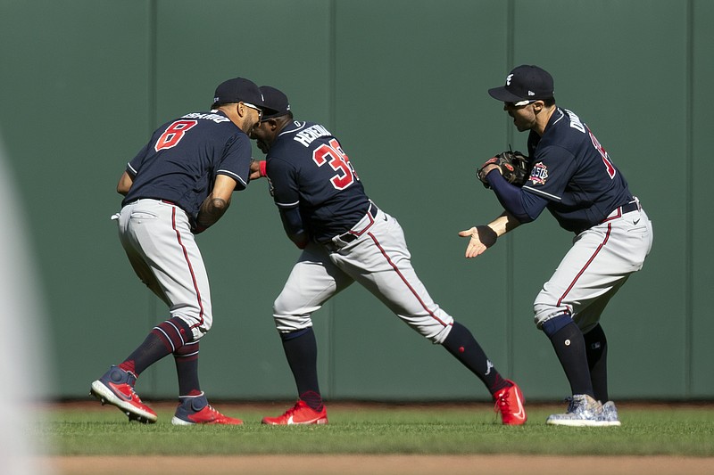 AP photo by D. Ross Cameron / From left, Atlanta Braves outfielders Eddie Rosario, Guillermo Heredia and Adam Duvall celebrate after the team's 3-0 victory over the host San Francisco Giants on Sunday.