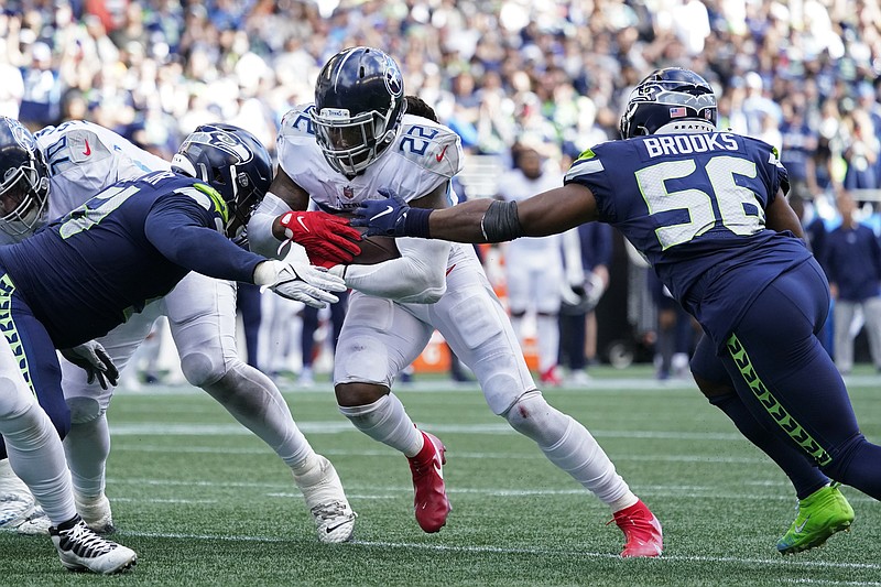 AP photo by Elaine Thompson / Tennessee Titans running back Derrick Henry is stopped just short of the goal line by Seattle Seahawks linebacker Jordyn Brooks and defensive end Kerry Hyder during the second half of Sunday's game in Seattle. Henry scored on the next play, and the extra point was good to tie the game at 30.