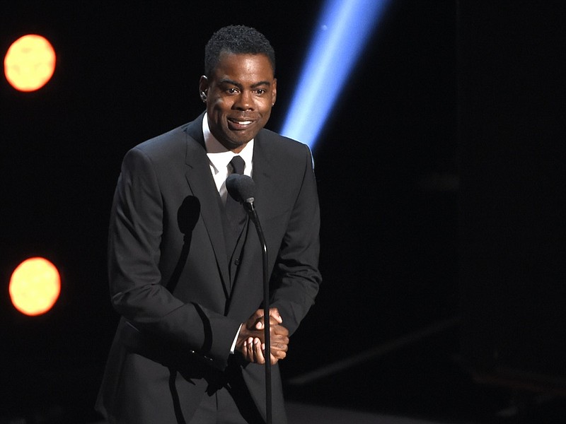 FILE - In this March 30, 2019 file photo, Chris Rock presents the award for outstanding comedy series at the 50th annual NAACP Image Awards at the Dolby Theatre in Los Angeles. Chris Rock on Sunday, Sept. 19, 2021 said he has been diagnosed with COVID-19 and sent a message to anyone still on the fence: "Get vaccinated." (Photo by Chris Pizzello/Invision/AP, File)