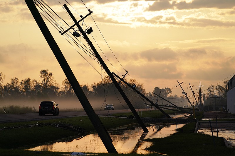 Downed power lines slump over a road in the aftermath of Hurricane Ida, Friday, Sept. 3, 2021, in Reserve, La. (AP Photo/Matt Slocum)