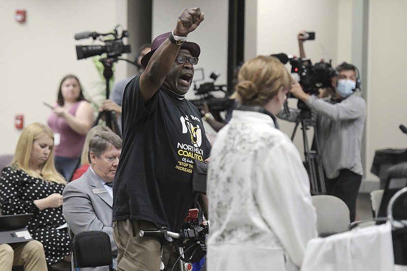 Photo by Bob Self / The Florida Times-Union via The Associated Press / In this June 10, 2021, file photo, Ben Frazier, the founder of the Northside Coalition of Jacksonville chants "Allow teachers to teach the truth" at the end of his public comments opposing the state of Florida's plans to ban the teaching of critical race theory in public schools during the Department of Education meeting in Jacksonville, Fla. Local school boards around the country are increasingly becoming cauldrons of anger and political division, boiling with disputes over such issues as COVID-19 mask rules, the treatment of transgender students and how to teach the history of racism and slavery in America.