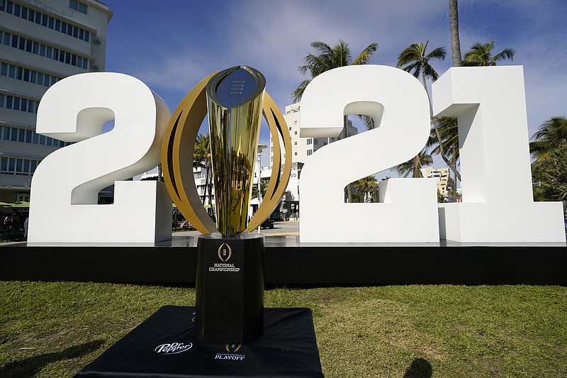 AP photo by Lynne Sladky / The trophy for the College Football Playoff national championship game is displayed in January on Ocean Drive in Miami Beach, Fla.