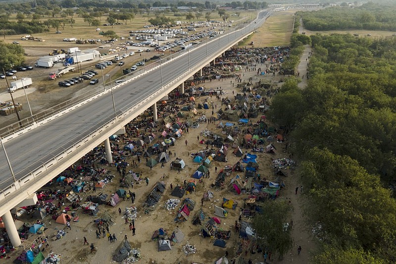 Migrants, many from Haiti, are seen at an encampment along the Del Rio International Bridge near the Rio Grande, Tuesday, Sept. 21, 2021, in Del Rio, Texas. (AP Photo/Julio Cortez)


