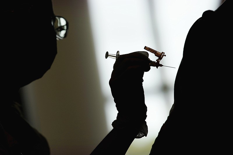 AP File Photo/John Locher / A nursing student administers the Moderna COVID-19 vaccine earlier this year at a vaccination center at the University of Nevada at Las Vegas in Las Vegas.