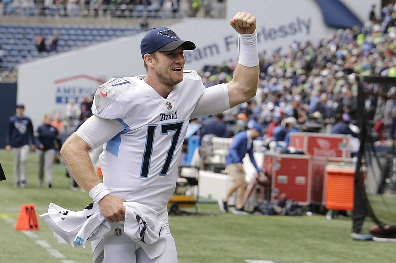 AP photo by John Froschauer / Tennessee Titans quarterback Ryan Tannehill celebrates as he runs off the field after his team beat the host Seattle Seahawks 33-30 in overtime on Sunday.
