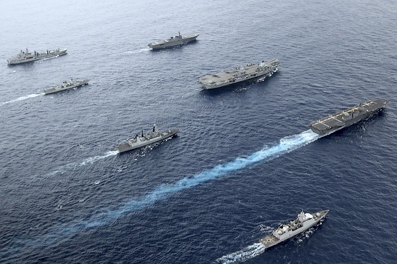 Front to back; HNLMS Evertsen, JS Izumo, HMS Defender, HMS Queen Elizabeth, HMCS Winnipeg, JS Ise, RFA Tidespring. UK Royal Navy Carrier Strike Group 21 HMS Queen Elizabeth, HMS Defender, RFA Tidespring and HNLMS Evertsen from CSG21 sails with Japanese ships JS Izumo and JS Ise along with the Canadian ship HMCS Winnipeg in the Pacific Ocean, Sept. 2021. (UK Ministry of Defence via AP)


