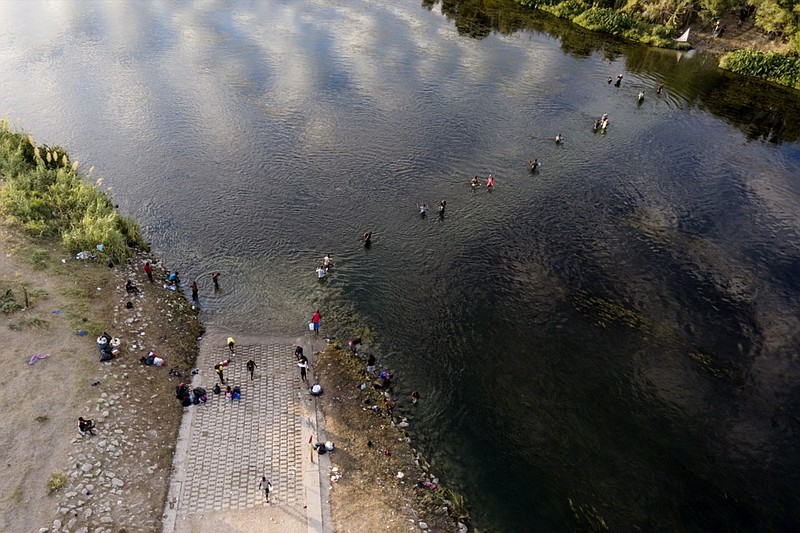 Migrants, many from Haiti, wade back and forth between Texas and Mexico across the Rio Grande, Wednesday, Sept. 22, 2021, in Del Rio, Texas. (AP Photo/Julio Cortez)


