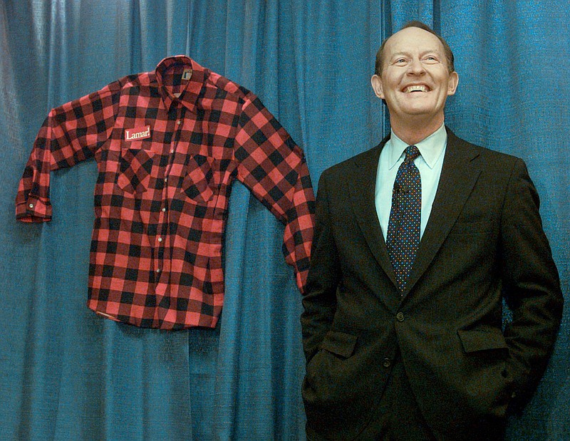 AP File Photo/Beth A. Keiser / Former Tennessee Gov. Lamar Alexander poses in 1996 with the shirt he wore during his walk across the state during his 1978 gubernatorial campaign.
