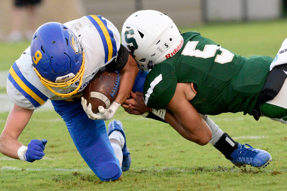 Staff Photo by Robin Rudd / Silverdale's Bryson Qualls (5) stops Donelson's Jacob Cook (9) for a loss. The Silverdale Academy Seahawks hosted the Donelson Christian Academy Bobcats in TSSAA football on September 24, 2021.