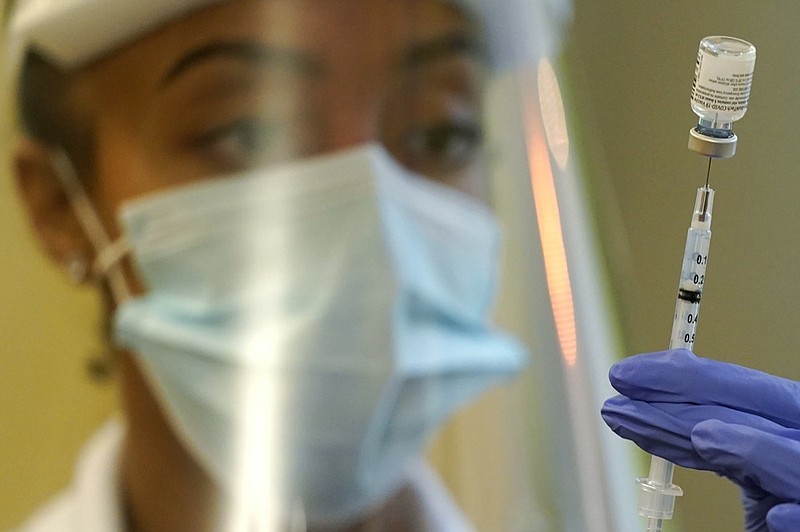 FILE - In this Jan. 8, 2021, file photo, a pharmacist prepares a syringe of the Pfizer vaccine for COVID-19, at Queen Anne Healthcare, a skilled nursing and rehabilitation facility in Seattle. (AP Photo/Ted S. Warren, File)


