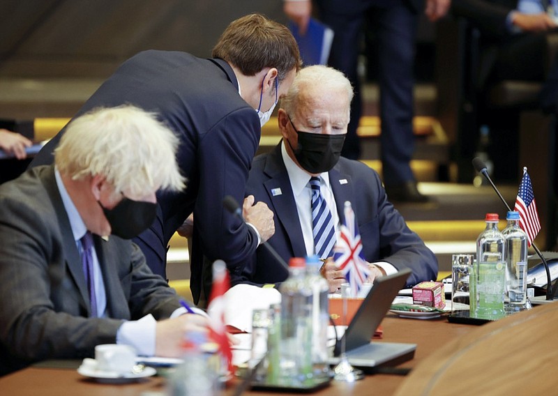 FILE - In this June 14, 2021, file photo French President Emmanuel Macron, center, speaks with U.S. President Joe Biden, right, during a plenary session at a NATO summit in Brussels. (AP Photo/Olivier Matthys, Pool, File)


