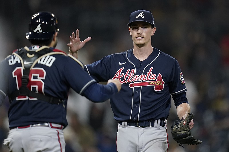 AP photo by Gregory Bull / Atlanta Braves pitcher Max Fried, right, celebrates with catcher Travis d'Arnaud after throwing a complete game in a 4-0 win against the host San Diego Padres on Friday night.