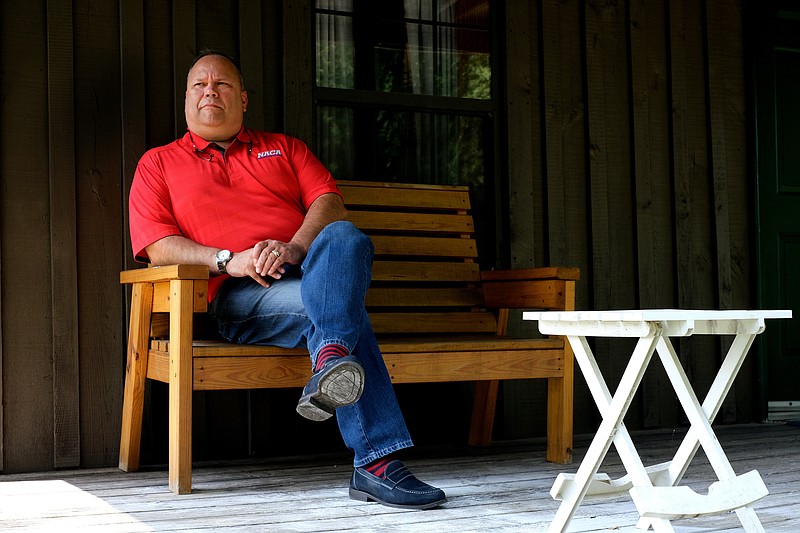 Staff photo by Wyatt Massey / John Ballinger, president of the National Association for Christian Athletes, sits outside a building at the Fort Bluff Camp in Dayton, Tenn., on July 21, 2021.