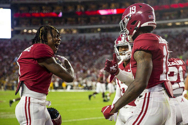 AP photo by Vasha Hunt / Alabama wide receiver Jameson Williams, right, celebrates with tight end Jahleel Billingsley, left, after Billingsley scored a touchdown during the first half of Saturday night's game against Southern Miss in Tuscaloosa, Ala.