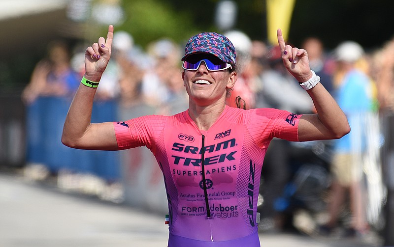 Staff photo by Matt Hamilton / Skye Moench celebrates as she approaches the finish line on Sunday at the Little Debbie Ironman in Chattanooga. About 2,000 athletes competed in the triathlon that started at 7:30 a.m. with swimming, continued with bicycling and ended with a marathon.