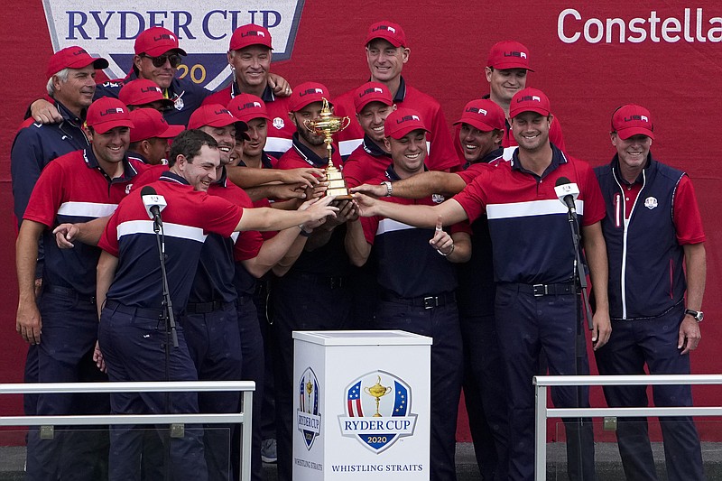 AP photo by Jeff Roberson / The U.S. team poses with the trophy at Sunday's closing ceremony after the 43rd Ryder Cup matches at Whistling Straits in Sheboygan, Wis. Baylor School graduate Harris English, second from right, was one of six rookies on a young team that won 19-9.
