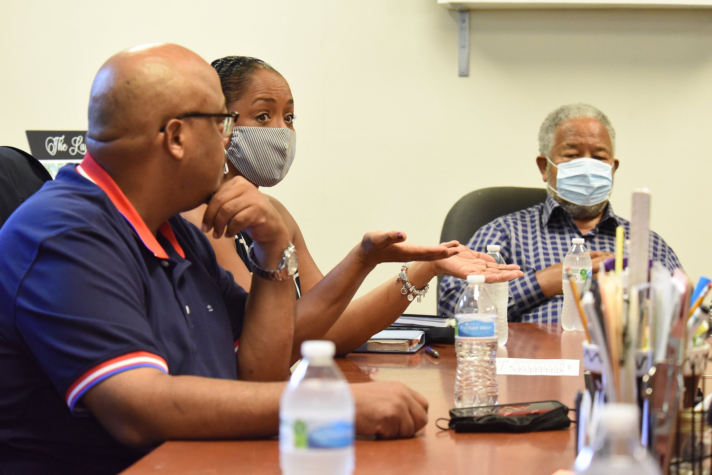 Staff Photo by Matt Hamilton / From left, Charles Adamson, Brenda Jean Adamson and Bobby Joe Adamson talk during a meeting at the Adamson Builders office on Brainerd Road in August.