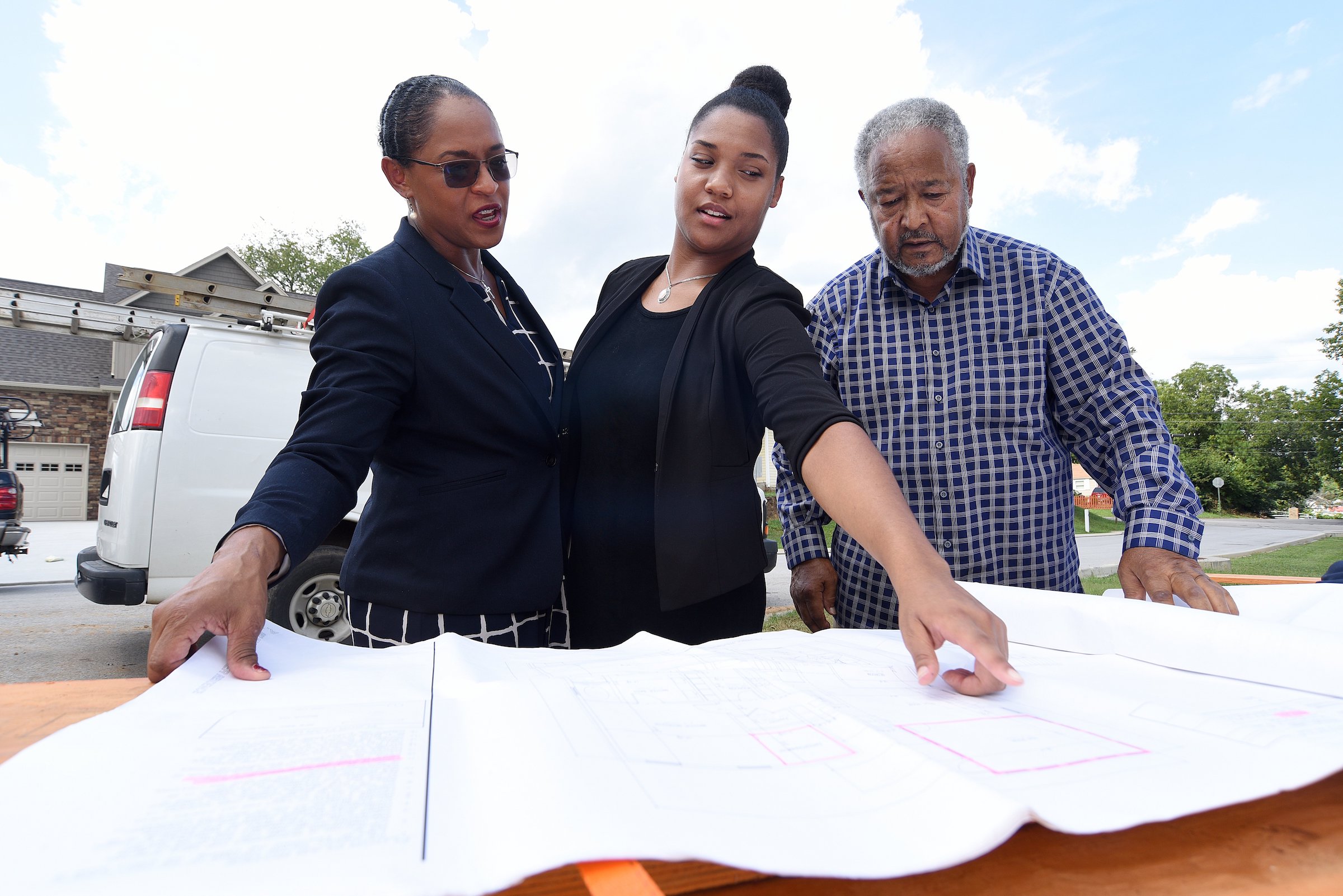 Staff Photo by Matt Hamilton / Bobby Joe Adamson, right, Lydia Cothran, middle, and Brenda Jean Adamson, left, look over house plans at Mapp Estates in August.