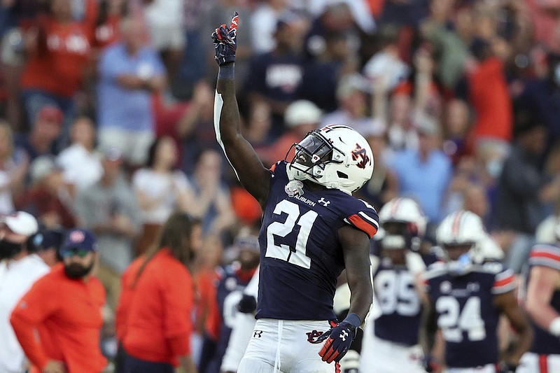 Auburn safety Smoke Monday (21) celebrates after returning an interception for a touchdown in the final minute of the second half of an NCAA football game to secure the win over Georgia State, Saturday, Sept. 25, 2021, in Auburn, Ala. Auburn won 34-24. (AP Photo/Butch Dill)
