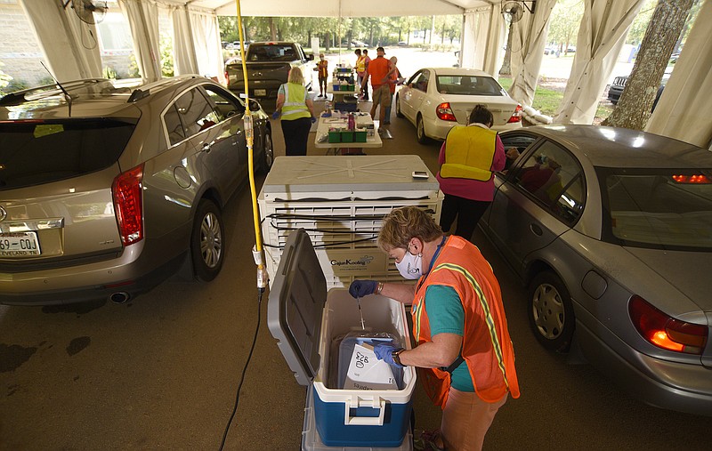 Staff Photo by Matt Hamilton / Nurse Susan Johnson takes a dose of COVID-19 vaccine from a cooler at the Tennessee Riverpark on Tuesday, Sept. 28, 2021. The Hamilton County Health Department continues to administer doses of the COVID-19 vaccine at the Tennessee Riverpark location.
