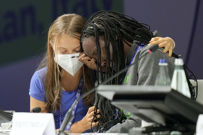 Ugandan climate activist Vanessa Nakate, right, is comforted by Swedish activist Greta Thunberg as she is overcome by emotion after speaking at the opening ofathree-dayYouth for Climatesummit in Milan, Italy, Tuesday, Sept. 28, 2021.(AP Photo/Luca Bruno)