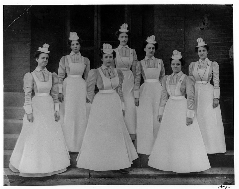 Photo courtesy of Erlanger Medical Center / Erlanger School of Nursing students pose for a class photo in 1902. Note their distinctive caps, unique to each school of nursing, and their blue and white starched uniforms.