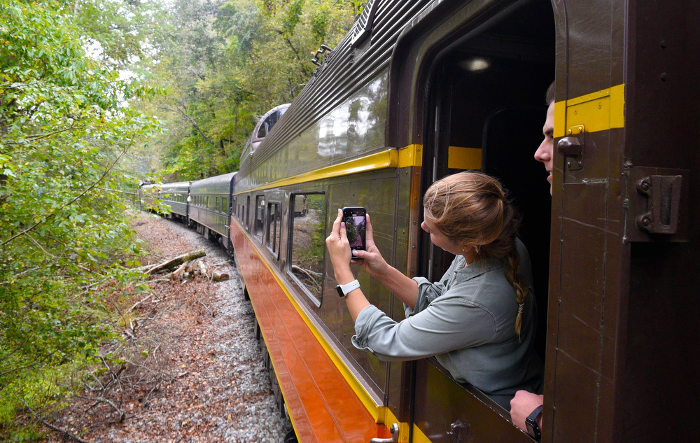 Staff Photo by Robin Rudd/ A passenger films the trip with her phone from one of the the he Tennessee Valley Railroad Museum's