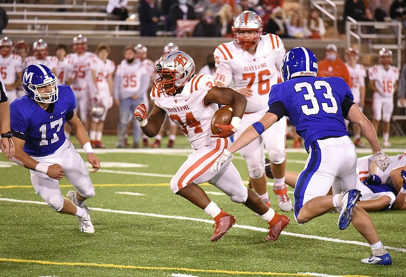 Staff photo by Matt Hamilton / Caleb Hampton runs the ball for Baylor during the rivalry game against McCallie in October 2020.
