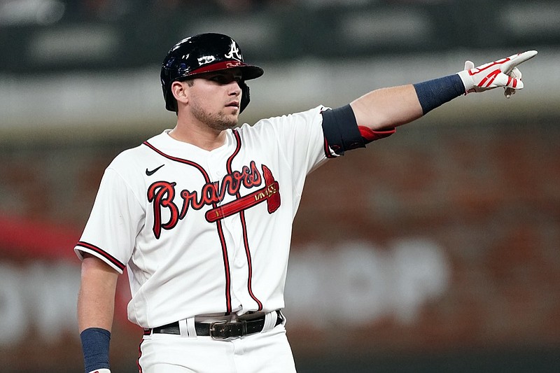 Atlanta Braves third baseman Austin Riley (27) gestures towards the Braves' dugout after hitting a two-run double in the seventh inning of a baseball game Philadelphia Phillies Wednesday, Sept. 29, 2021, in Atlanta. (AP Photo/John Bazemore)
