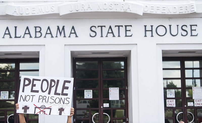 People protest the prison plan outside the Alabama State House in Montgomery, Ala., on Wednesday, Sept. 29, 2021. (Jake Crandall /The Montgomery Advertiser via AP)


