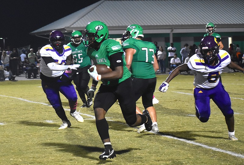 Staff photo by Patrick MacCoon / East Hamilton running back Juan Bullard runs down the left sideline in the first half against Central on Friday night.