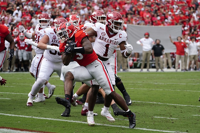 AP photo by John Bazemore / Georgia running back Zamir White gets past Arkansas defensive back Jalen Catalon (1) to score a touchdown during the first half of Saturday's SEC game in Athens, Ga. White ran for two touchdowns and recovered a blocked punt for another as the Bulldogs won 37-0, winning back-to-back SEC games by shutout for the first time since 1980.