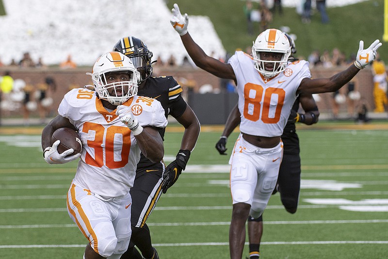 AP photo by L.G. Patterson / Tennessee running back Marcus Pierce Jr. (30) scores a touchdown as teammate Ramel Keyton celebrates during the second half of Saturday's 62-24 SEC win at Missouri.