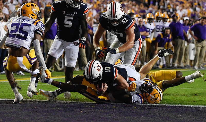 Auburn photo by Todd Van Emst / Auburn junior quarterback Bo Nix dives into the end zone during Saturday night's 24-19 win at LSU.