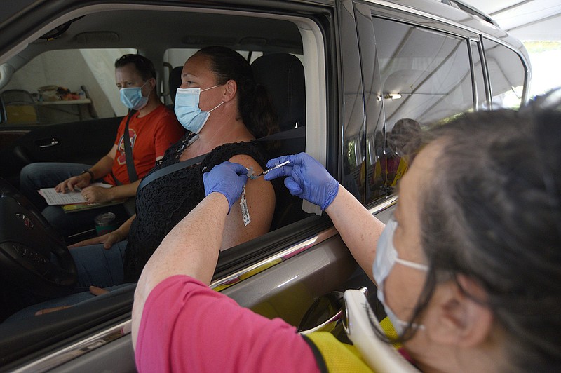 Staff Photo by Matt Hamilton / Nurse Vicki Reinshagen administers a dose of the COVID-19 vaccine to Chattanooga resident Martha Carpenter at the Tennessee Riverpark on Tuesday, Sept. 28, 2021.