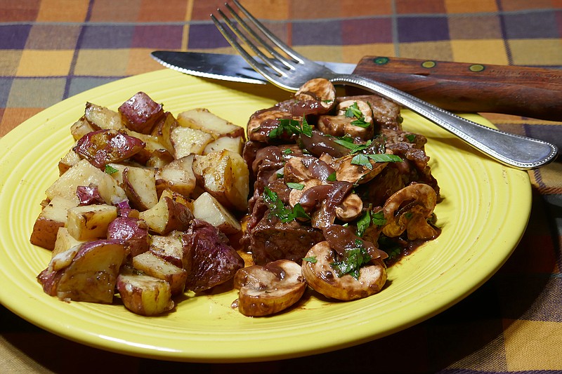 Steak in Red Wine Sauce with Garlic Potatoes. / Photo by Linda Gassenheimer/TNS