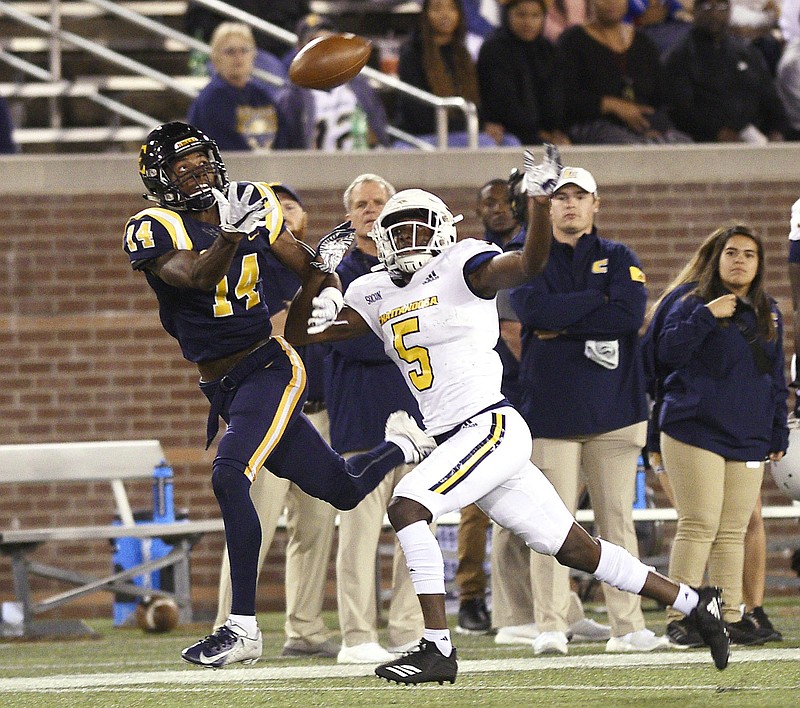 Staff Photo by Robin Rudd/ East Tennessee's Keith Coffee (14) goes for a reception as CaMiron Smith (5) defends for UTC. Smith was called for interference on the play. The University of Tennessee at Chattanooga Mocs hosted the East Tennessee State University Buccaneers in Southern Conference football at Chattanooga's Finely Stadium on October 17, 2019.