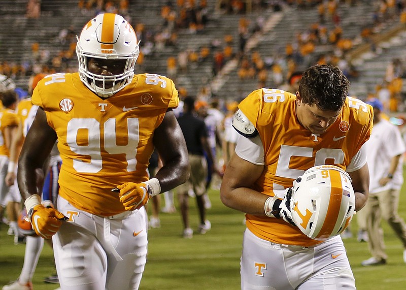 Staff photo by C.B. Schmelter / Tennessee defensive lineman Matthew Butler (94) and offensive lineman Riley Locklear (56) walk off the field after falling to the Florida Gators 47-21 at Neyland Stadium on Saturday, Sept. 22, 2018 in Knoxville, Tenn.