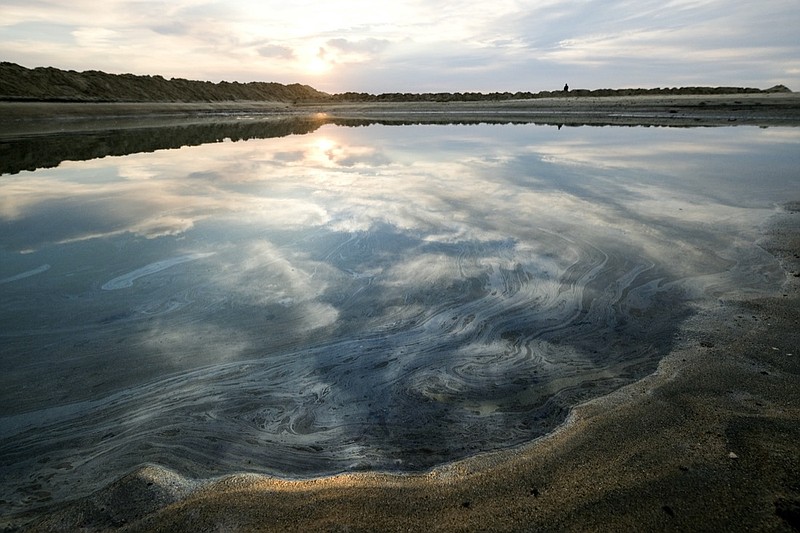 Oil floats on the water surface after an oil spill in Huntington Beach, Calif., on Monday, Oct. 4, 2021. A major oil spill off the coast of Southern California fouled popular beaches and killed wildlife while crews scrambled Sunday, to contain the crude before it spread further into protected wetlands. (AP Photo/Ringo H.W. Chiu)