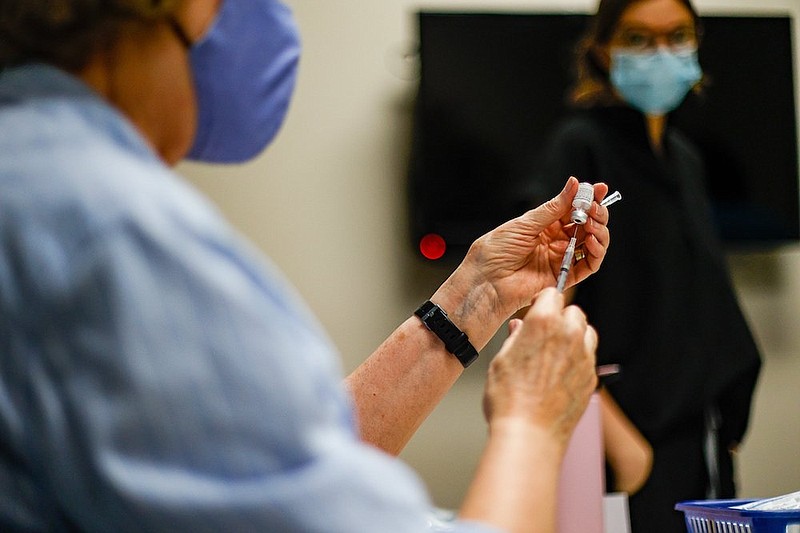 Staff photo by Troy Stolt / Robin Hoffecker fills doses of the Pfizer COVID-19 vaccine during a student vaccination event at Chattanooga State Community College on Friday, Aug. 20, 2021, in Chattanooga, Tenn.