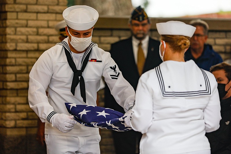 Staff photo by Troy Stolt / Two U.S. Navy sailors fold a flag for Melissa Gail Miner, a homeless veteran, during her funeral service at Chattanooga National Cemetery on Wednesday, Oct. 6, 2021 ,in Chattanooga, Tenn.