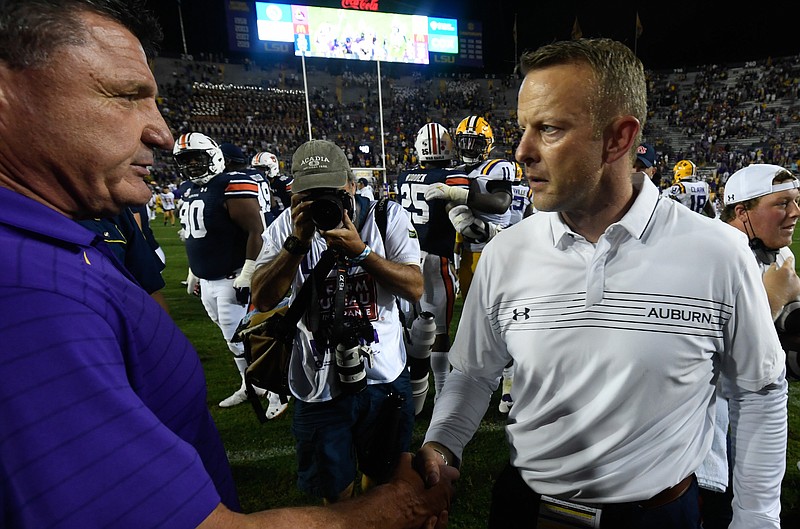 Auburn photo by Todd Van Emst / Disappointed LSU coach Ed Orgeron, left, shakes hands with Auburn's Bryan Harsin last Saturday night after Auburn's 24-19 triumph at LSU.