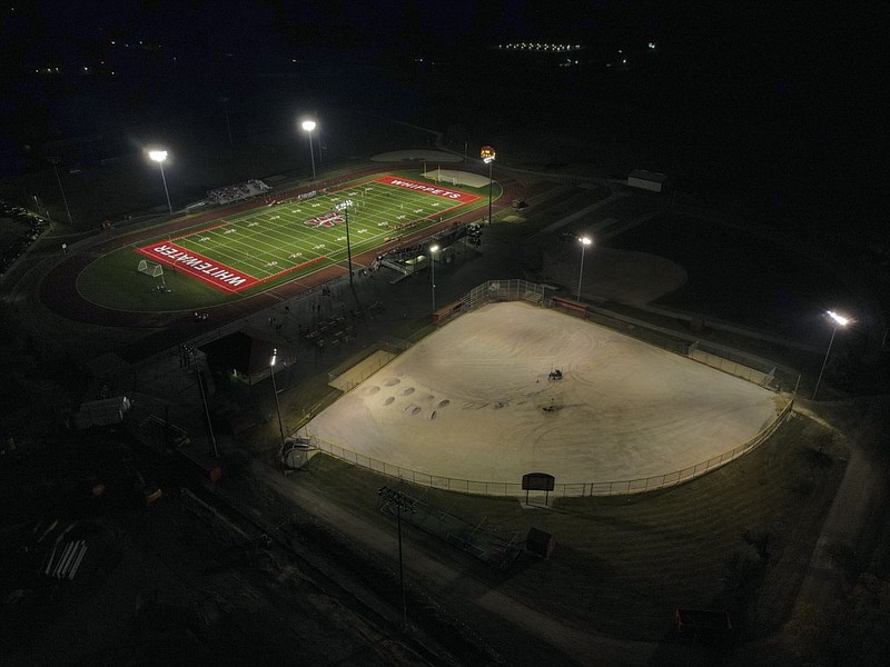 A football field, top, and baseball field under construction are lit up at Whitewater High School Friday, Oct. 1, 2021, in Whitewater, Wis. (AP Photo/Morry Gash)


