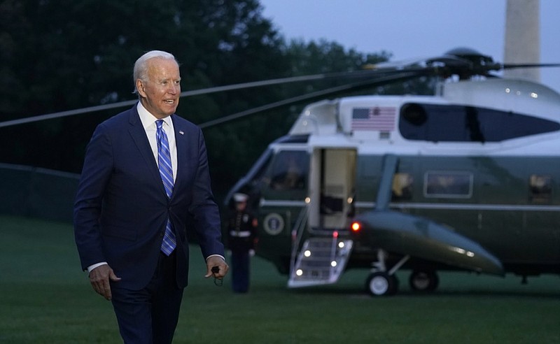 President Joe Biden talks with reporters after returning to the White House in Washington, Tuesday, Oct. 5, 2021, after a trip to Michigan to promote his infrastructure plan. (AP Photo/Susan Walsh)


